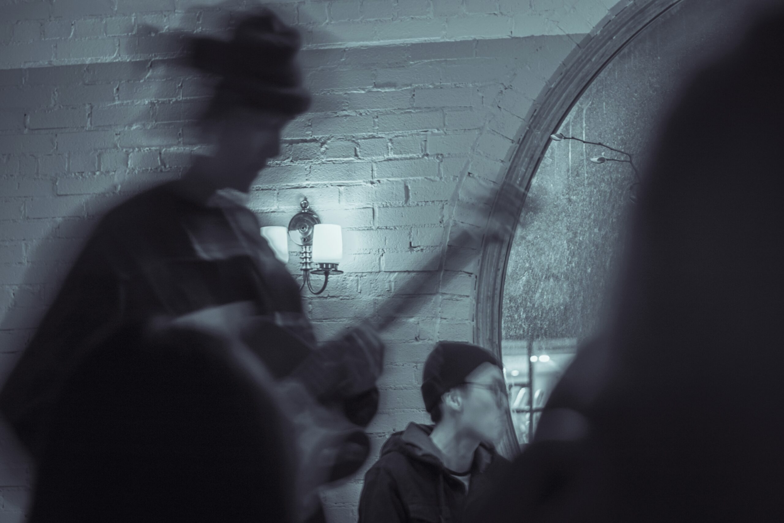 a man standing in front of a mirror holding a guitar